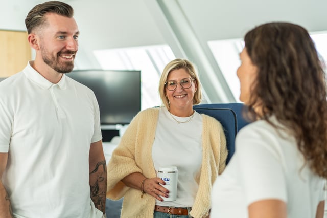 man and woman smiling and holding a beverage