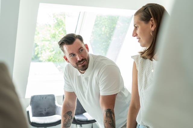 man looking at woman in an office
