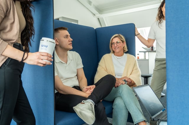 people sitting on a sofa and talking