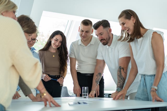 people standing around a table laughing