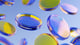 Abstract floating translucent discs in blue, yellow, and pink tones on a light blue background