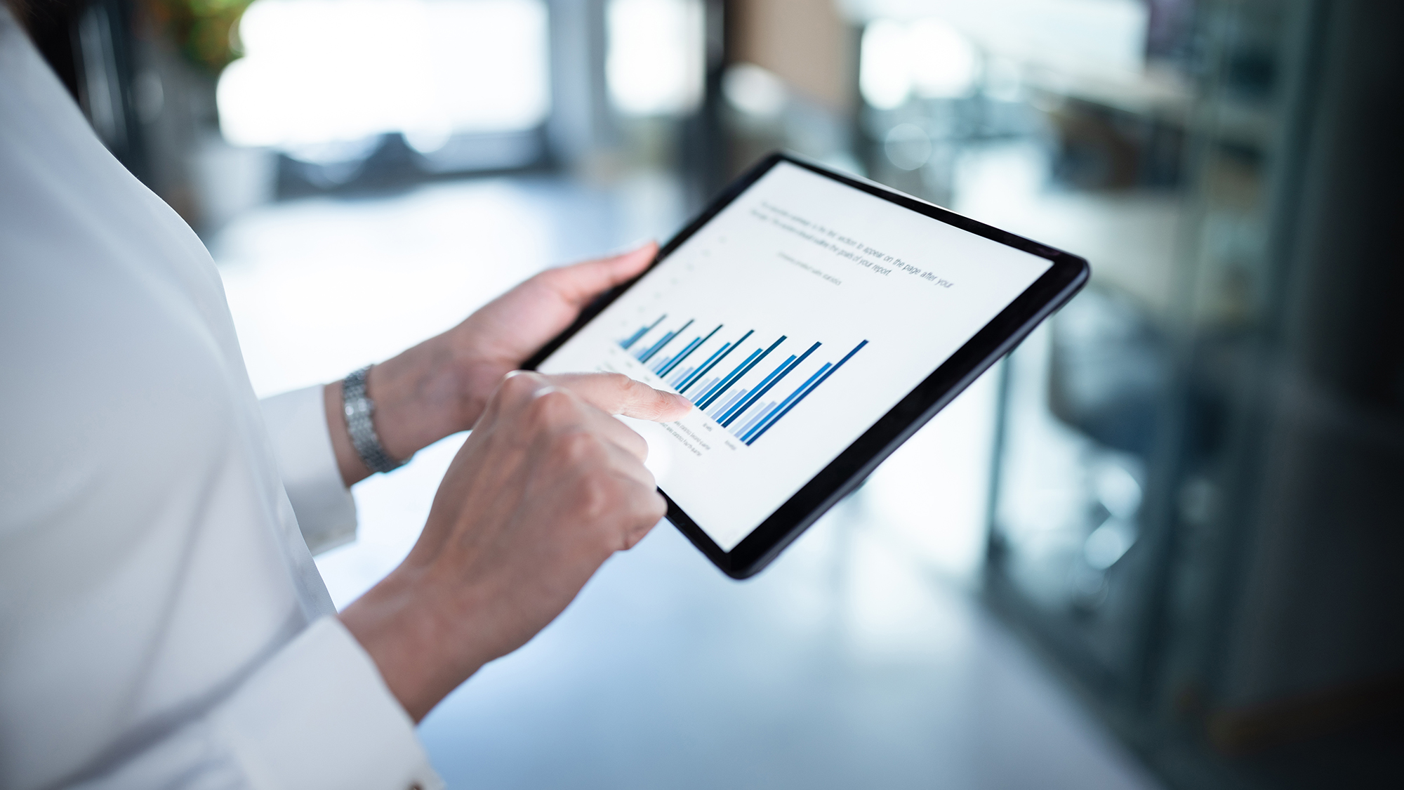 Woman holding and iPad which displays a diagram